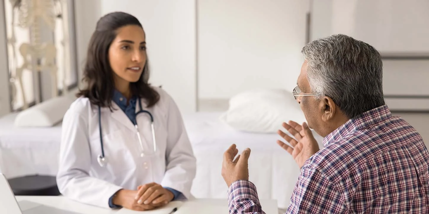 Paciente conversando com a médica sobre quando considerar a cirurgia de Parkinson